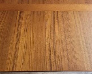 Close-up view of extension leaf on teak dining table