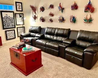 Large media theater recliners.  Notice the John Flemming leather masks!