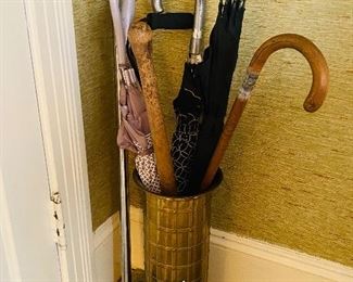 Brass umbrella stand with canes, and umbrellas