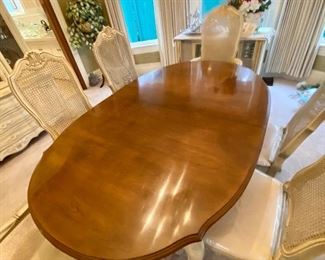 French Provincial dining table with 8 chairs,  plus two leaves. Excellent condition. Comes with custom table top pads