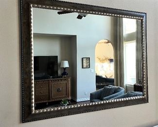 Several very large beveled mirrors, framed