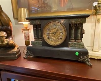 Cool old antique clock and French lamp to the left.