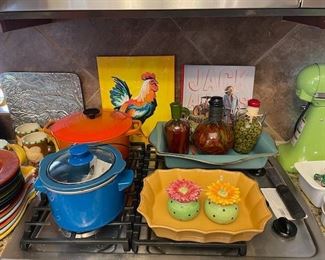 Lots of colorful kitchenware and a signed Jack Allen's Kitchen book