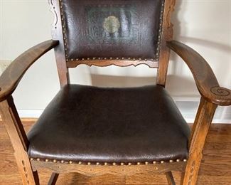 Antique oak chair with leather upholstery and nail head trim
