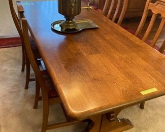German made oak trestle table with six chairs with upholstered seats