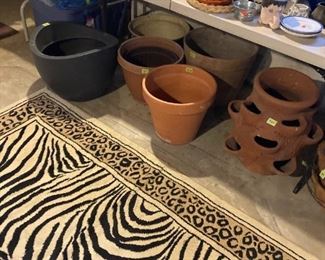 Several flat carpets and area rugs in many styles and colors. Tons of Plant pots and picnic wares.