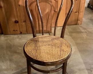 One of four bentwood chairs with caned seats