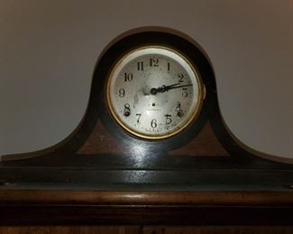Mantle clock has inlaid accent pieces flanking both sides