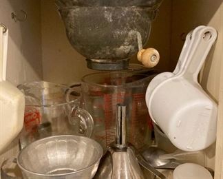 Assorted kitchenware including Pyrex, measuring cups, mixing bowls, small appliances