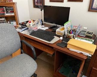 Office desk, chair and office supplies.