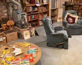 shot across basement with mineral slab tab le & old comics