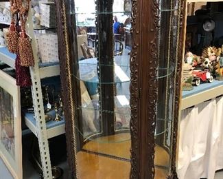 2 richly carved baroque renaisance curio cabinets.  Mirrors make it look round but they are half moon style with 3 glass shelves.
