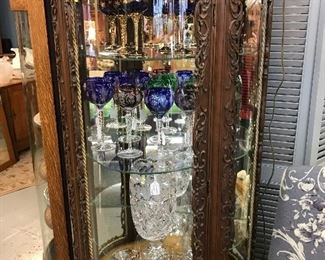 Another picture of one of the incredible richly carved renaissance Baroque China cabinet with beautiful Cobalt, Amethyst, Green and Red Stemmed goblets, Bphemian Cobalt Stemed Glasses, Imperilux Cut Crystal Vase 10" 