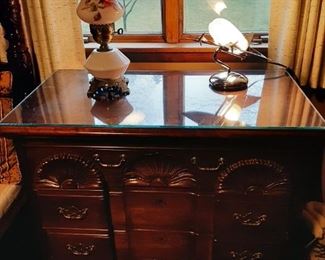 A small dresser or large nightstand