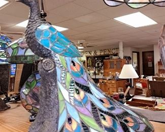 Many stained glass table lamps.  Peacock table lamp