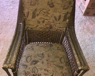 Forward View Of This Quality Ornate Wicker Antique Rocker With Original Upholstery From The Family Boathouse Circa 1929-1931. THE BEMIS RIDDELL FIBRE CO. IN SHEBOYGAN, WIS., WAS COMMISSIONED IN 1929-1931 TO MANUFACTURE THE FAMILY WICKER COLLECTION OF FURNITURE - RARE ORIGINAL UPOLSTERY IN TAPESTRY DESIGNS