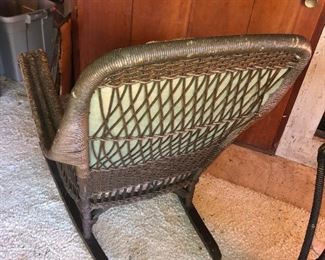 Back View Of Thickness Of The Back Quality Ornate Wicker Antique Rocker With Original Upholstery From The Family Boathouse Circa 1929-1931. THE BEMIS RIDDELL FIBRE CO. IN SHEBOYGAN, WIS., WAS COMMISSIONED IN 1929-1931 TO MANUFACTURE THE FAMILY WICKER COLLECTION OF FURNITURE - RARE ORIGINAL UPOLSTERY IN TAPESTRY DESIGNS