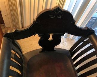 CLOSE UP VIEW OF PERIOD ORNATE MAHOGANY ARMCHAIR WITH WOOD SECTIONAL ARMS AND HIGHLY CARVED CREST BACK