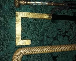 Close Up View Of 2 Vintage Cane Handles, One Snakeskin, One Italian & 1 Victorian 19th Century Rolled Gold Umbrella Handle