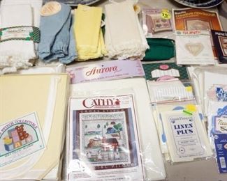 1309	LARGE LOT OF INCLUDING CROSS STITCH KITS, CROSS STITCH AID CLOTH OF DIFFERENT WEAVES AND SIZES, AID QUILTS, TABLE CLOTH, HAND TOWLS AND MORE
