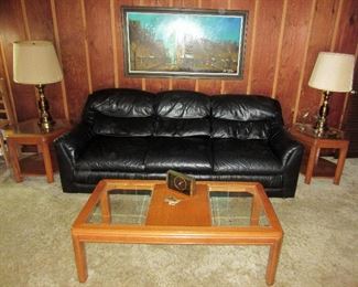 Black leather sofa, lamps, and tables.  Signed oil painting.