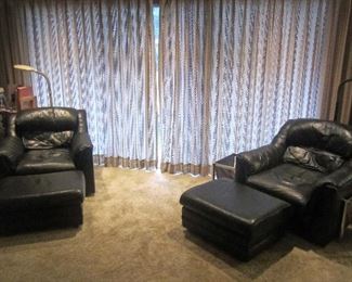 Black leather chairs with ottomans