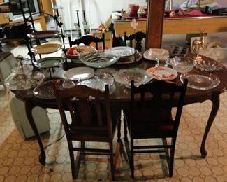 Nice dining room table with assorted vintage chairs, great serving pieces too