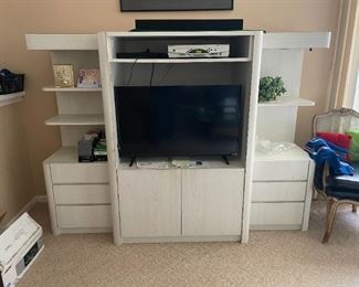 Wall unit. Does come apart in 3 pieces. Custom shelving inside for video.