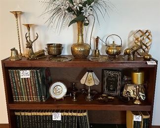 Horizontal Bookcase; World Book 50th Anniversary Encyclopedias, Dictionaries and Atlas; Brass Decor; Brass Animals; Brass Striker Pot; Brass Candle Holders; Brass Bells; Sleigh Bell