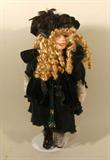 Porcelain Girl Doll with Golden Hair and Green Velvet Dress