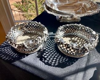 #45). Pair of sterling wine coasters with pierced sides and a border of leaves.   Wood base.  
