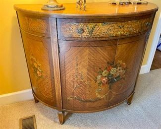 Hand painted French Demilune cabinet. 36” H. 43” W. 20” D
