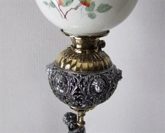 Lot 11   C/1890 Victorian GWTW Oil Lamp, converted, original hand painted rose decorated ball shade, polished spelter and brass base w/cherub. (Figure has an open basket for burnt matches). 30 1/2" h. x 10" dia.  Condition:  Re-polished nicely, no damage found.  