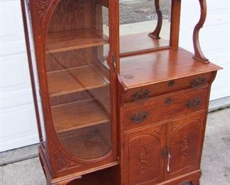 Lot 13   C/1880 Victorian Oak China/Server, includes both applied and incised carving, heavy brass hardware, brass galley rail on top, 3-shelf china section, velvet lined flatware drawer, 2-door open base for serving pcs with inner shelf. 67" h. x 48" w. x 20" deep.  Condition:  Minor scratches and wear to original finish.    