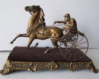 Lot 20   C/1890 Gilt Bronze Sculpture of a Harness Race Horse w/Sulky & Jockey mounted on a velvet wrapped wood base set into a Louis 16th style gilt brass frame, 9"h x 14" x 7", very detailed.  Condition:  Small area of corrosion on the sulky seat support, dark patina, small areas of wear from cleaning, velvet possibly replaced.   
