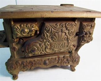 Lot 35   C/1910 Signed Kenton Cast Iron Child's Stove "Royal" model, 11" x 6 1/2" x 6 3/4" h.  Condition:  Chip to left side shelf, finish is turning dark, all stove eyes are original and present.  