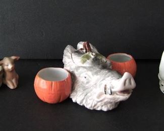 Lot 41    C/1900 German 3-piece porcelain Pig/Boar group including:  Boar head sauce container w/dbl. pumpkin side wells and a acorn decorated cover.  3" h. x 6" x 5".  Porcelain spill vase w/pigs in an Out House "Engaged", 4' tall w/"Made in Germany" on back, plus 2 baby pigs next to a wooden open wash bucket, 1 3/4" h. x 3 1/4" w.  Condition:  Minor wear, wear to gilt tusk and sm. chip inside edge of Boar head. No damage on the other pcs. 