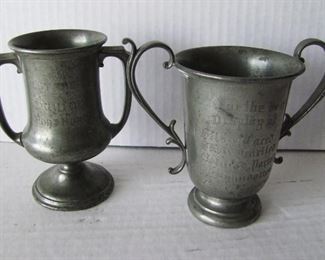 Lot 45   Pair of dated 1909 Pewter Trophy Cups from Port Huron, MI Fair for Best Displays of Exotic Chicken Breeds, both signed Reed & Barton, tallest 5 1/4" .  Condition:  Minor scuffs and scrapes.    