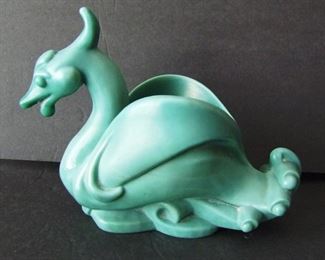 Lot 53   Art Deco dark opaque green glass Swan Vase, stylized swan form on water, satin finish, 5 /4" h. x 8" l. Very heavy casting, ground glass bottom, probably Austrian.   Condition: No damage found