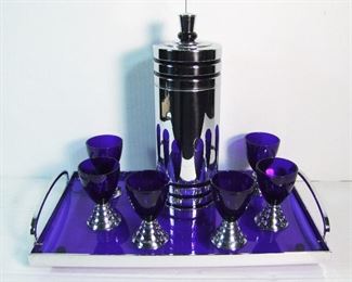 Lot 62   C/1930 8 Piece Art Deco signed "Chase" Chrome Cocktail Set w/shaker, 6 Cobalt glasses and a Cobalt & Chrome Serving  tray w/handles.  Shaker is 11 1/2" h., Cocktail glasses are 3 3/4" h., Tray is 16" x 9 1/2" x 2 3/4" h.  Condition:  Minor wear to shaker, no damage found.
