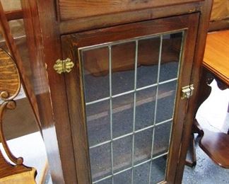 Lot 42A   C/1910 Pine Mission style Bookcase. Single leaded door. 26"w. X 14"d. X 50"h.    Condition: Refinished.       Est. $150 - 250  