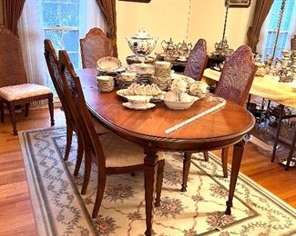 Dining room table w/6  cane back chairs and  2 leaves 