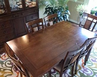 Dark wood table that measures 36x60 and comes with 6 chairs.