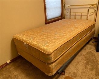 Twin bed with brass headboard
