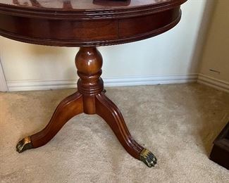 three footed, brass capped, round pedestal table