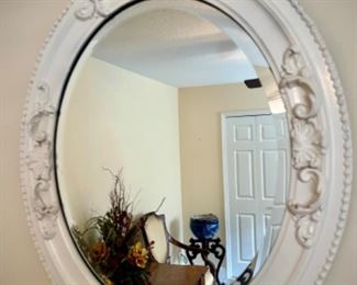 White oval mirror with carved frame