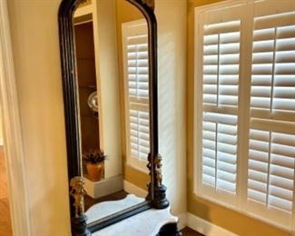 Tall mirror with marble stand and carved detail