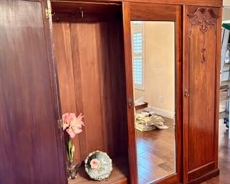 3-panel wood wardrobe with clothing rack, mirrored doors, and internal drawers