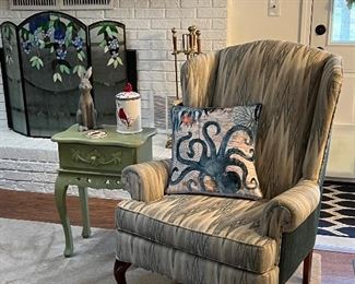 Wingback chair, small green end table,  stained glass fireplace screen 