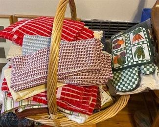 Basket filled with kitchen towels, mitts